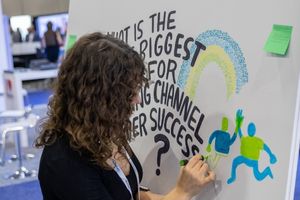 A photo of a person writing on a whiteboard at Channel Partners Conference and Expo