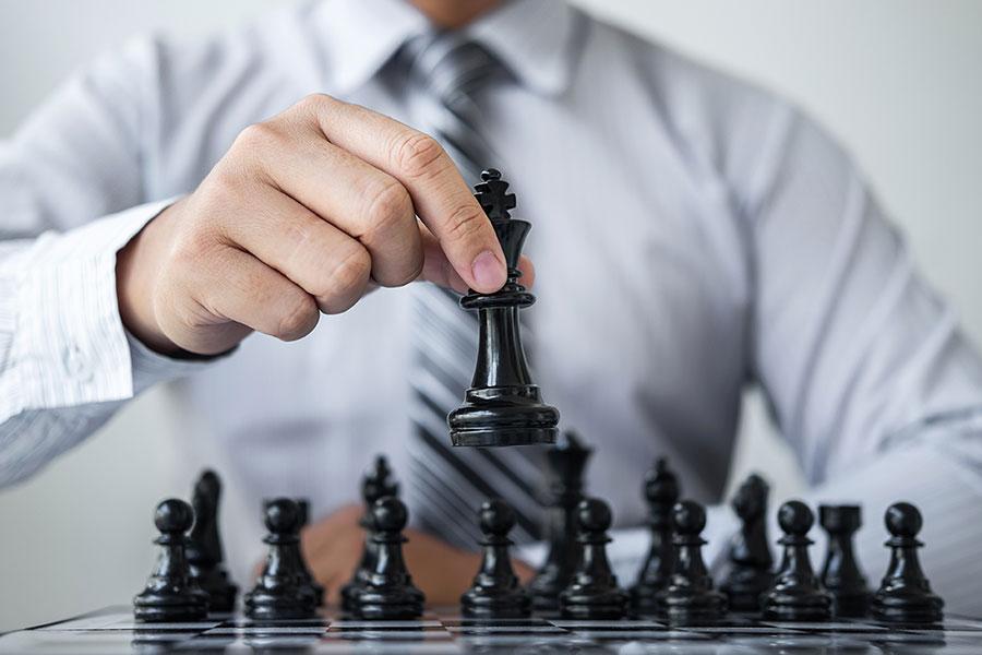 Prepare your battle plans Man playing chess